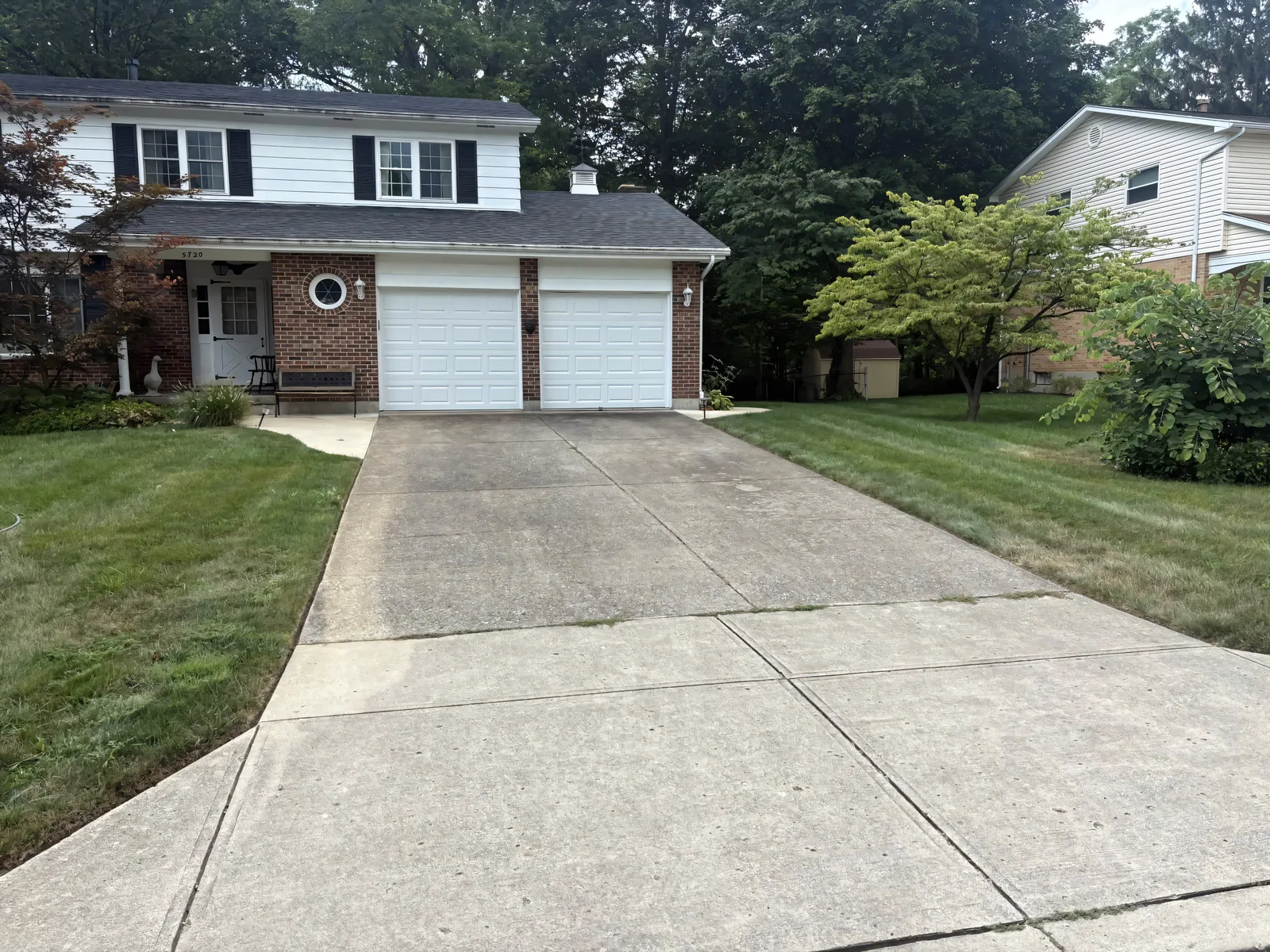 Wide-shot driveway after Stoltz pressure washing — original color fully restored