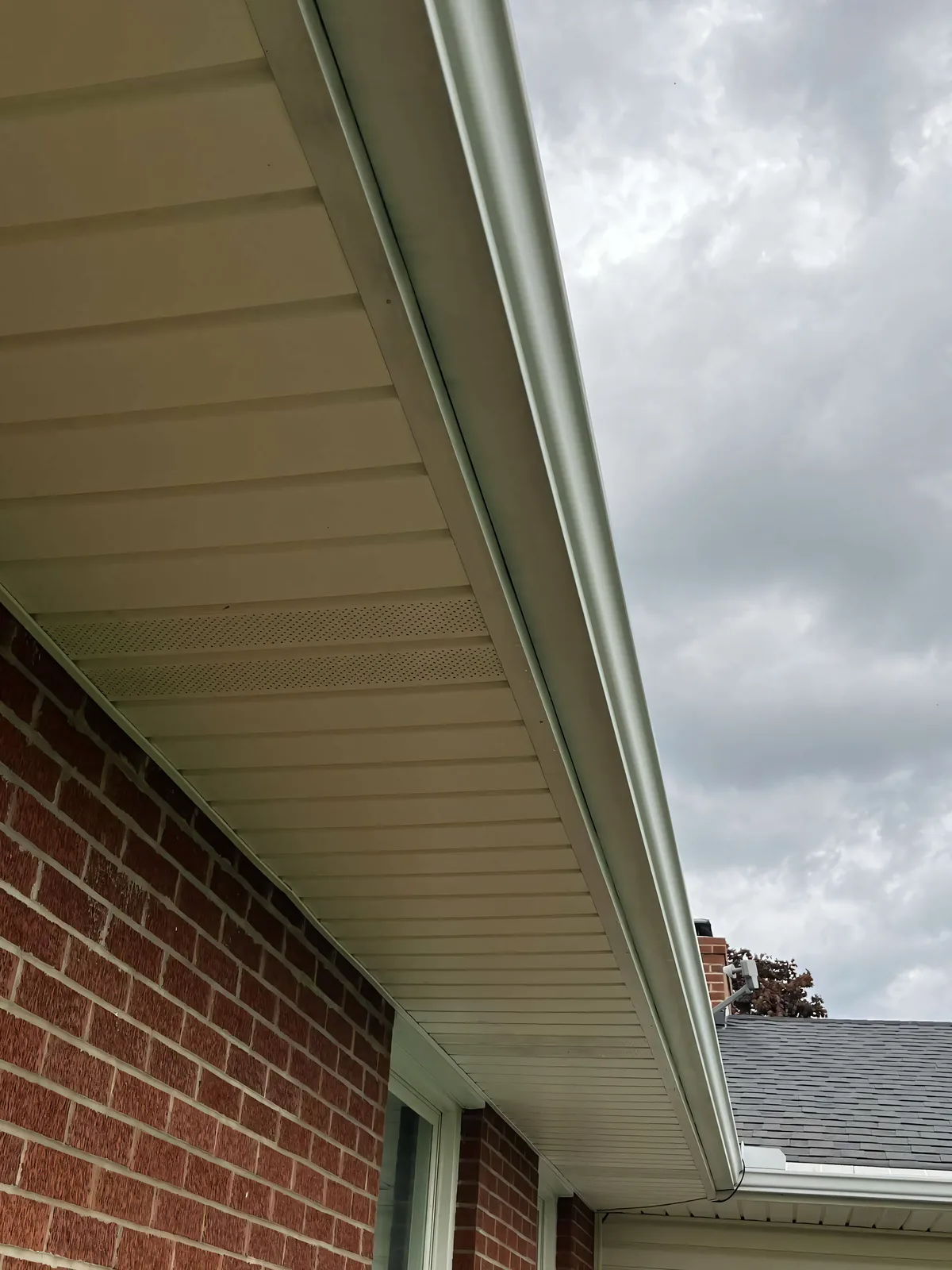 Clean gutters and soffit on a brick home after Stoltz gutter cleaning